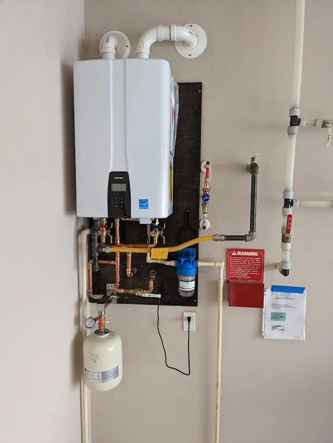 Professional plumber installing copper piping in a Laketown home